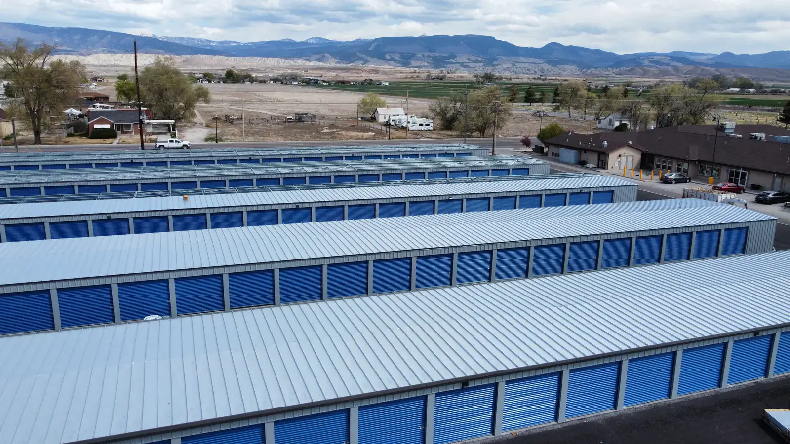 Pre-engineered metal self-storage building in Centerfield, Utah, aerial with the San Pitch Mountains behind