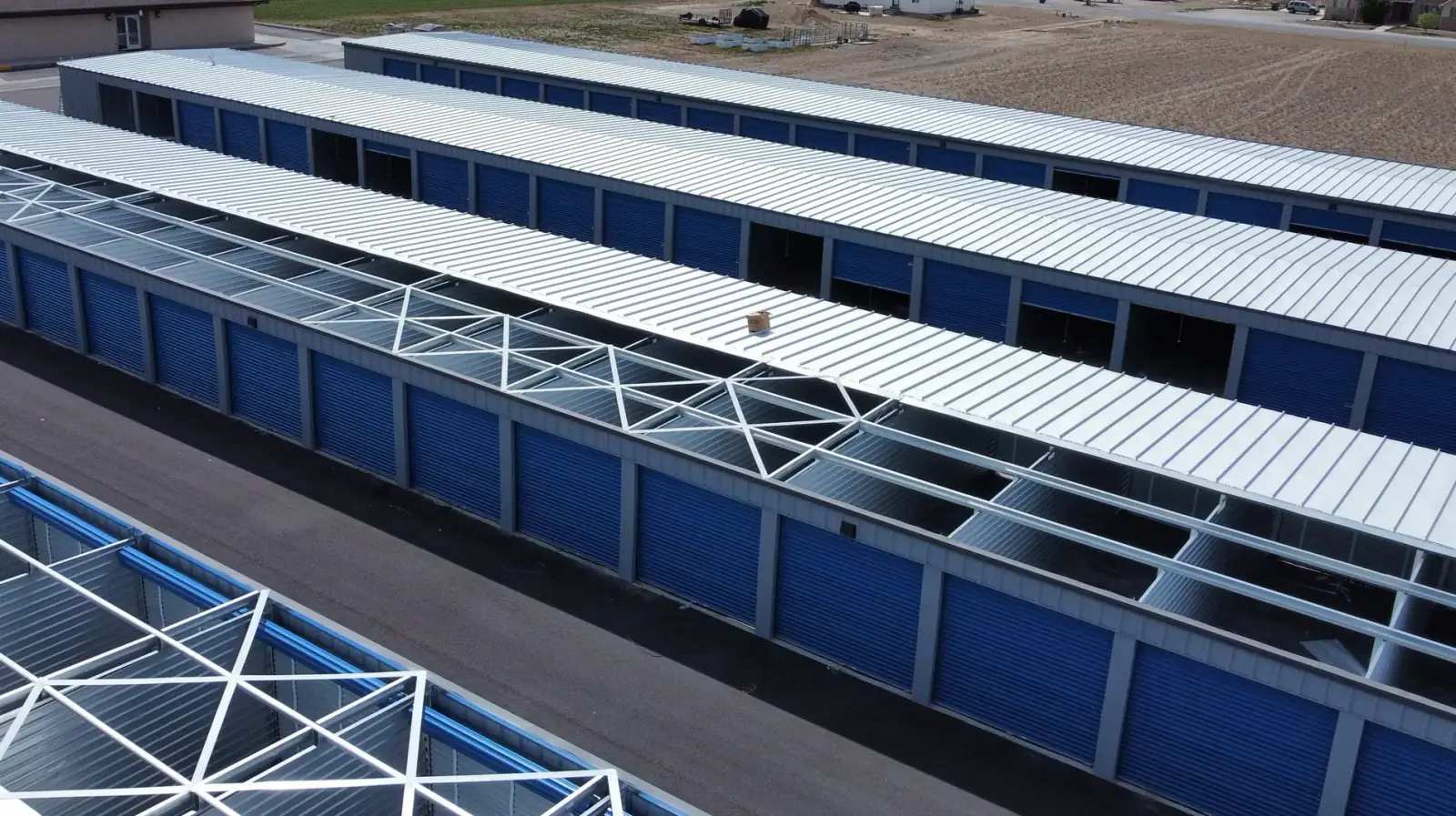Galvanized steel roof framing and X-bracing of a pre-engineered self-storage building under erection