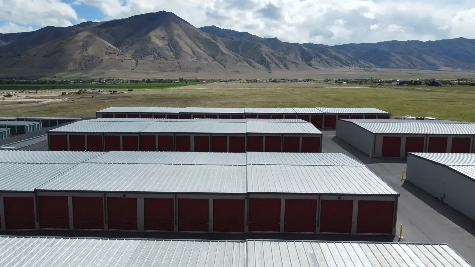 Pre-engineered metal self-storage building in Erda, Utah, aerial with the Stansbury Mountains behind
