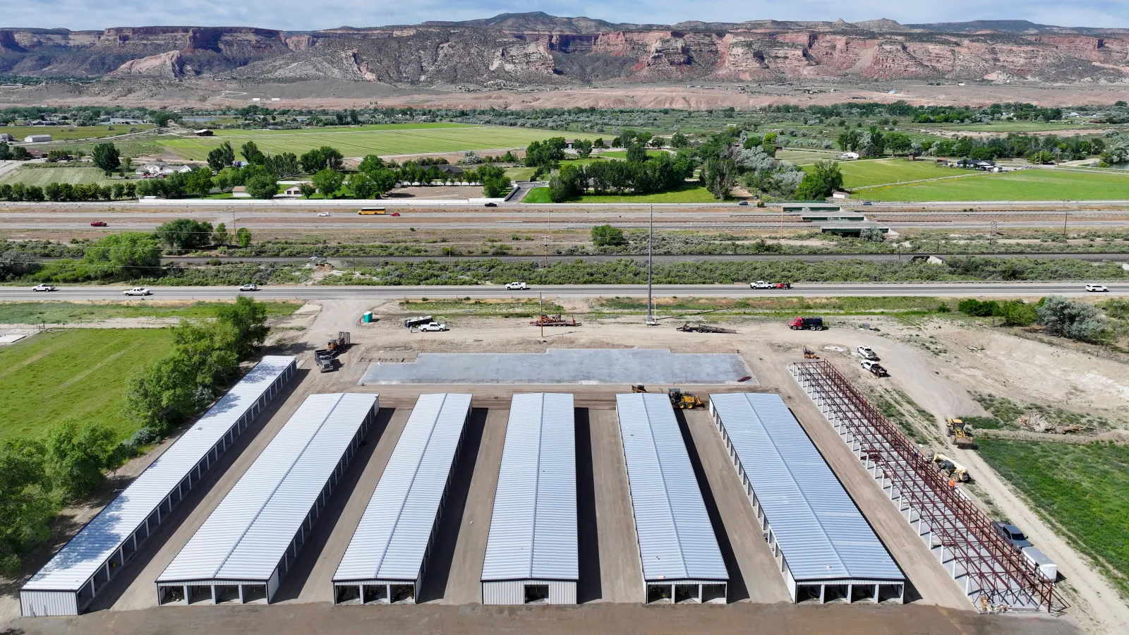 My Storage Fruita drive-up self-storage facility under construction in Fruita, Colorado, with the red-rock Book Cliffs and I-70 behind