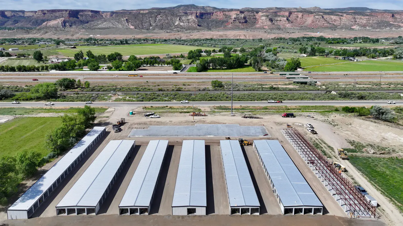 My Storage Fruita drive-up self-storage facility under construction in Fruita, Colorado, with the red-rock Book Cliffs and I-70 behind