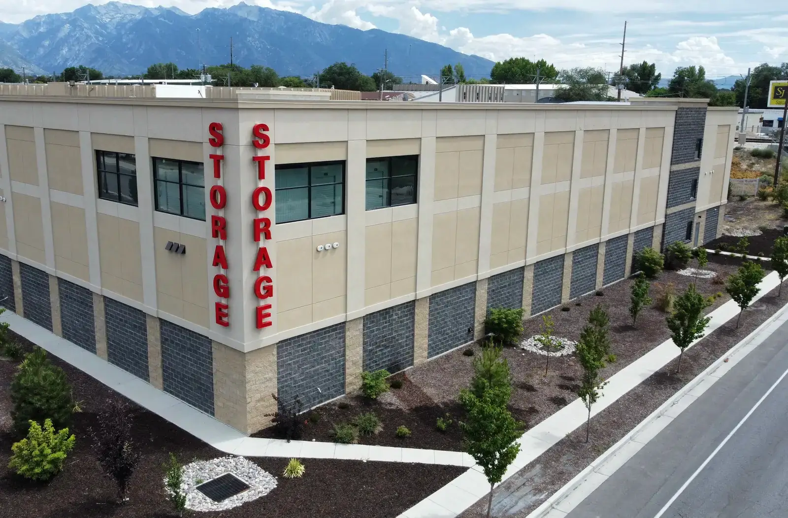 Multi-story pre-engineered steel self-storage building in Midvale, Utah, with Wasatch peaks behind
