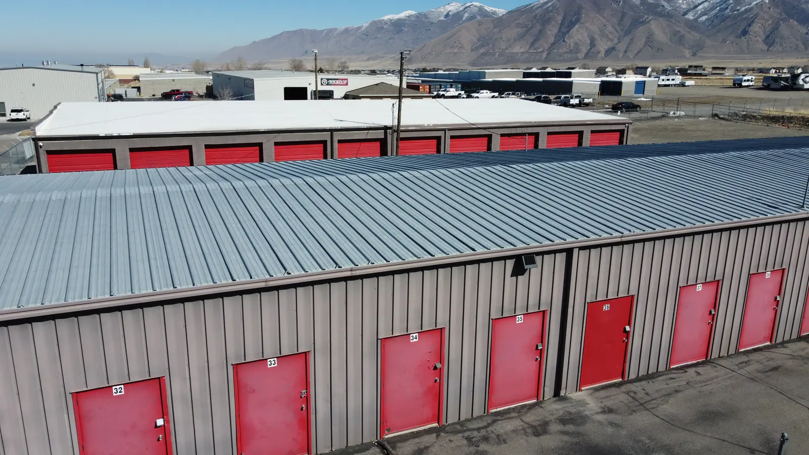 Red roll-up doors on a pre-engineered steel self-storage building in Tooele, Utah
