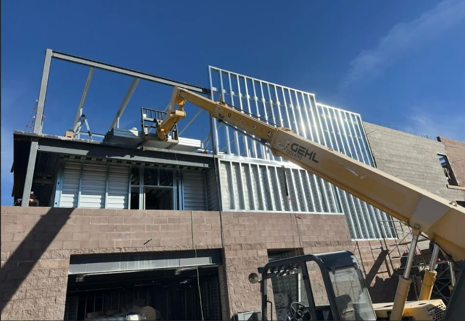 Crane lifting steel wall panels during construction of the multi-story Timp Hwy Self Storage in Lehi, Utah