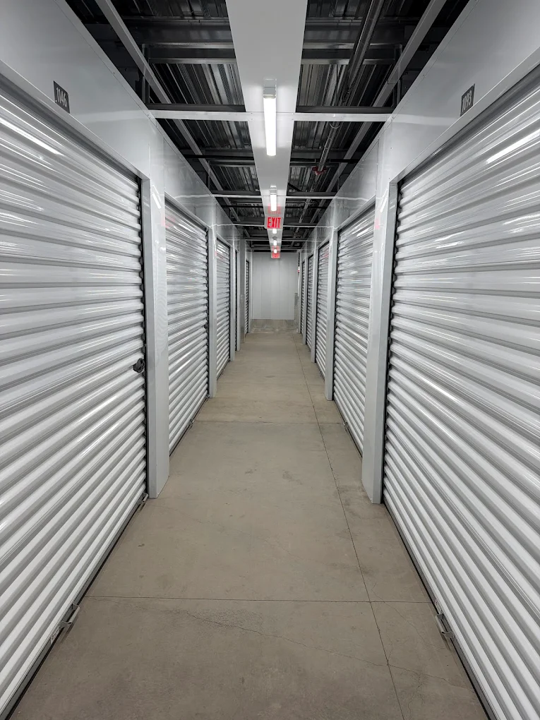 Climate-controlled interior corridor with gray roll-up doors at Timp Hwy Self Storage, Lehi Utah