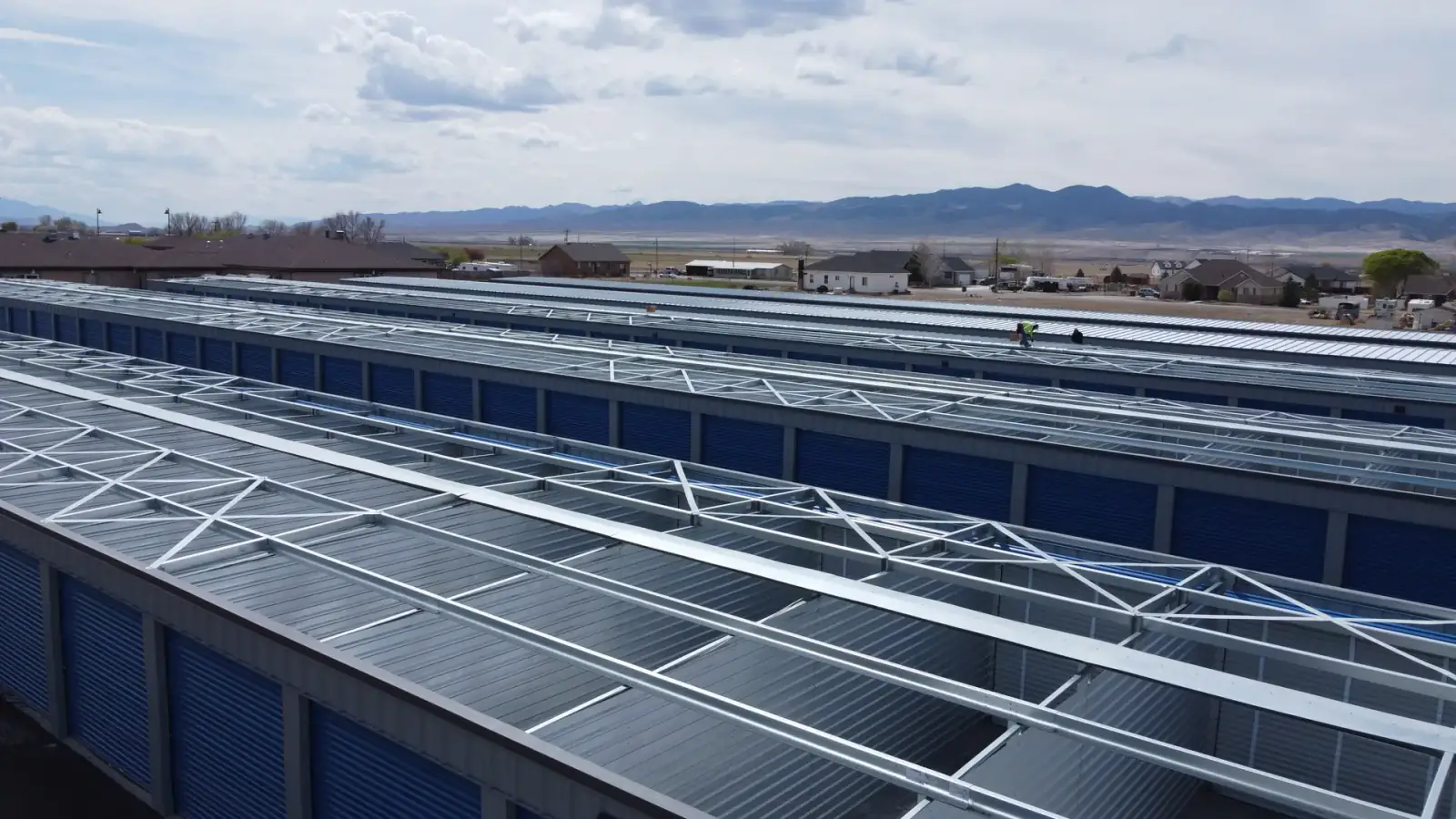 A self-storage building kit going up, long run of pre-engineered steel framing on site