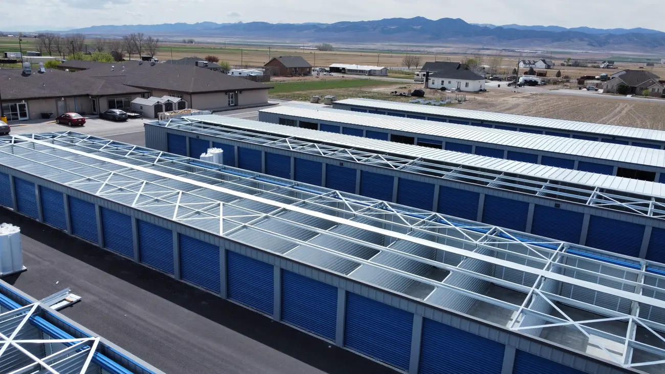 Pre-punched steel framing of a self-storage building kit mid-erection